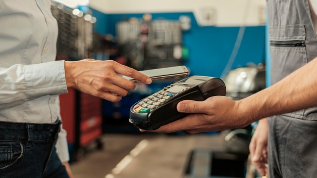 Closeup of Woman Making Payment Transaction With Her Mobile Phone