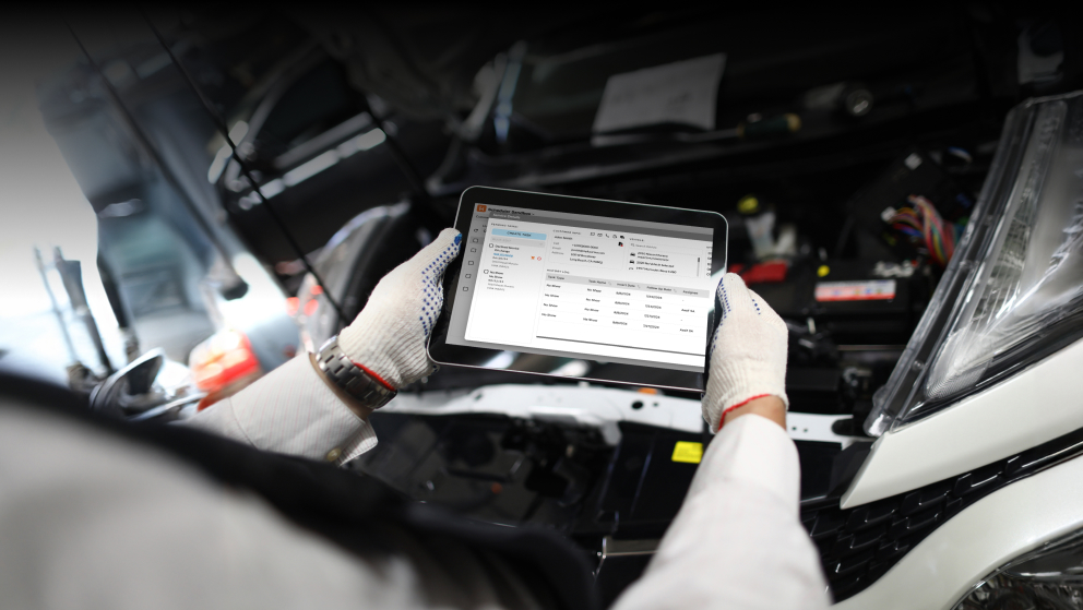 Close-up of mechanic worker using tablet for diagnostics of technical condition of vehicle