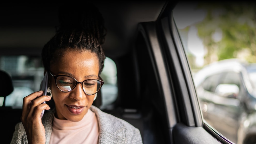 Mature woman talking on the mobile phone in the car