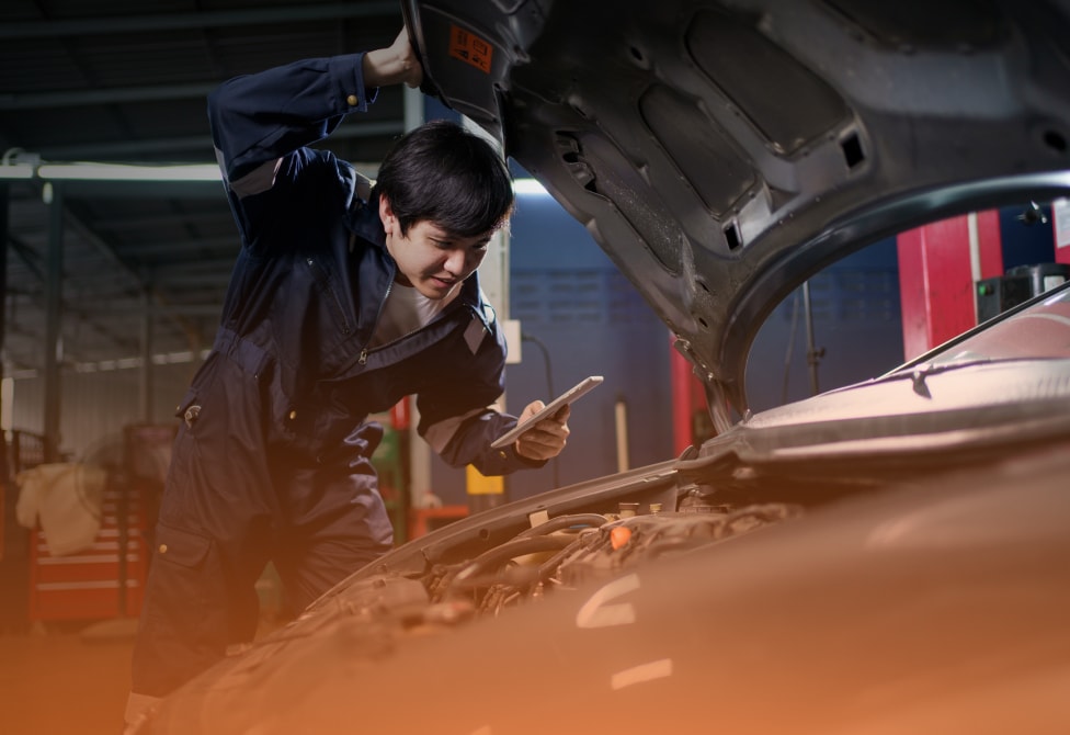 Mechanics taking a video of car engine