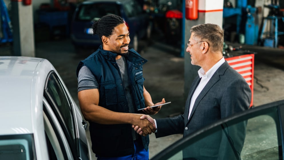 Mechanic shaking hands with happy customer