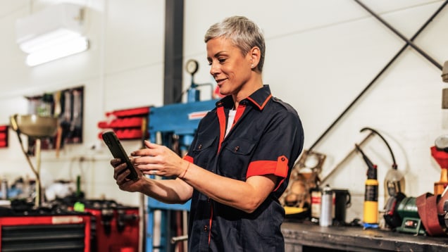 mechanic looking at smartphone