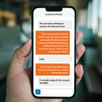 customer looking at smartphone displaying chat with Service pre-diag AI chat